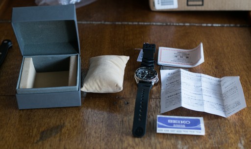 Seiko SKX007 Unboxing - The box included the watch, a soft display pillow, warranty information, and manual.